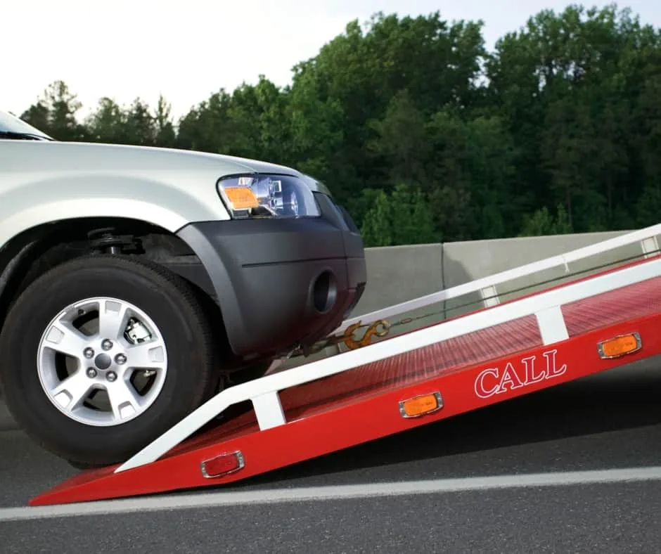 Burnaby tow truck loading a vehicle on a residential street