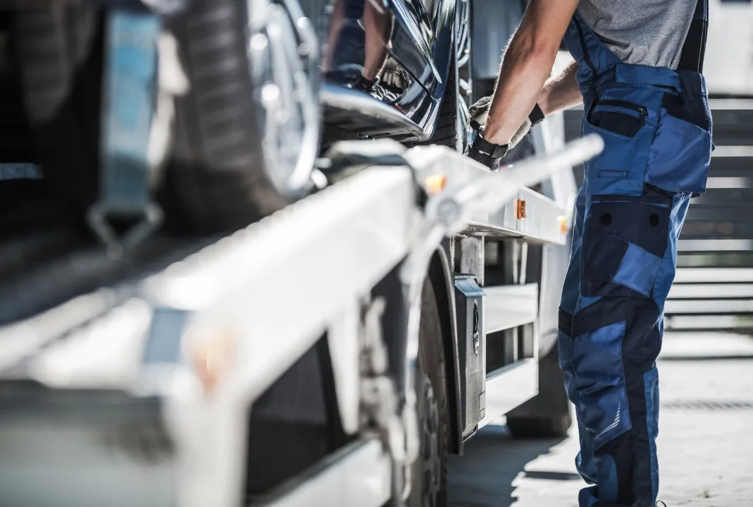 Burnaby tow truck driver loading a car onto a flatbed